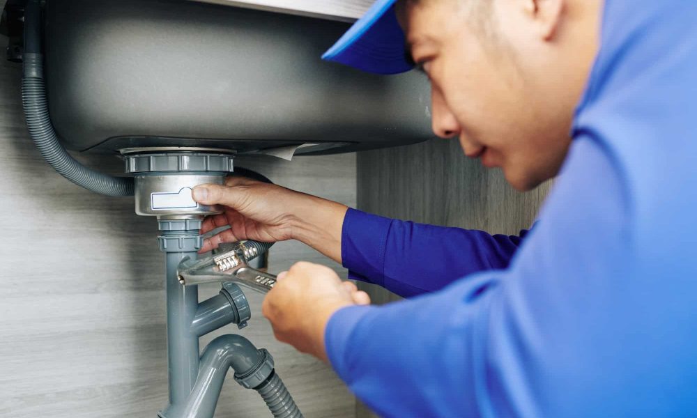 plumber-repairing-a-leaky-drain.jpg